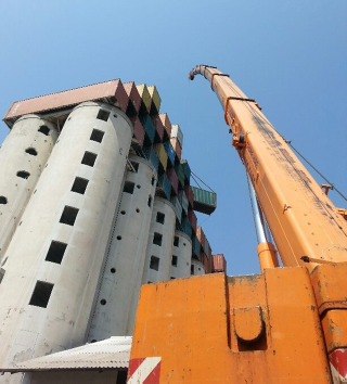 Illustration for article titled This Shipping Container City Above an Old Grain Silo Is Actually a Dorm